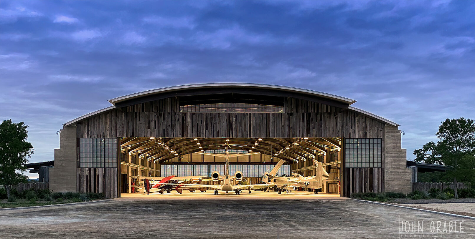 Ghost Hanger project exterior shot at night with airplanes parked inside