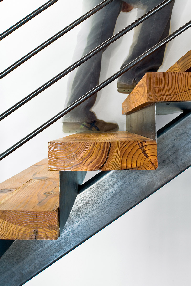 Interior shot of John Grable Architects office of someone walking up the stairs